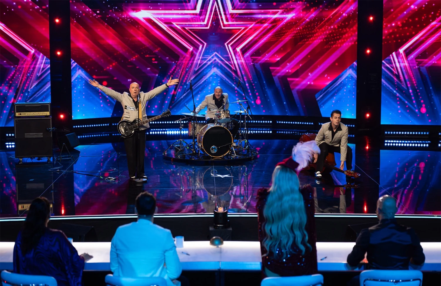 UK Rock ‘n’ Roll Trio Shines on International TV as Rockin’em Rocks Supertalent with Four Yeses!